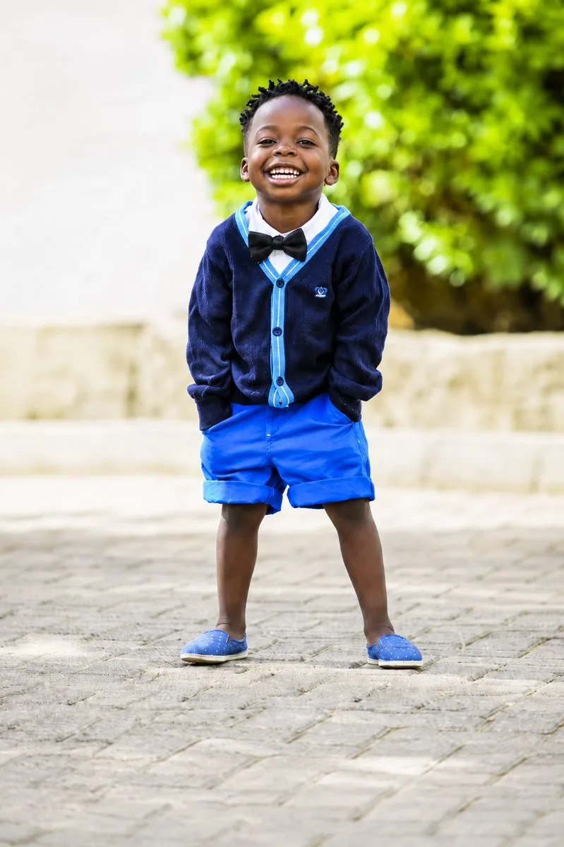 Smiling young child standing outdoors, representing the American Academy of Pediatrics digital transformation