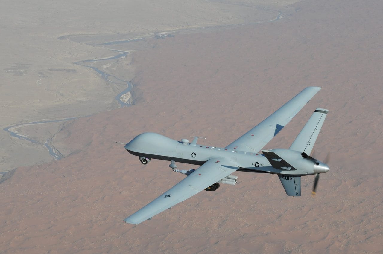 MQ-9 Reaper drone in flight over desert